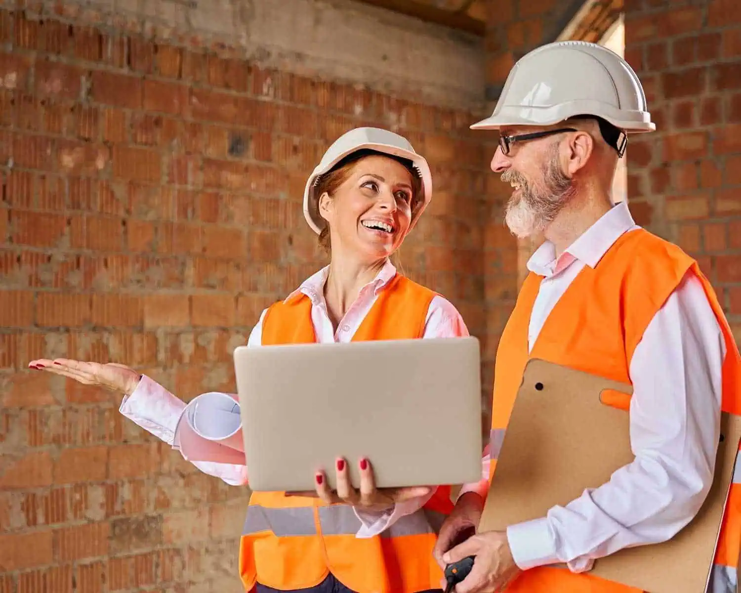 Construction professionals discussing project plans at a building site.