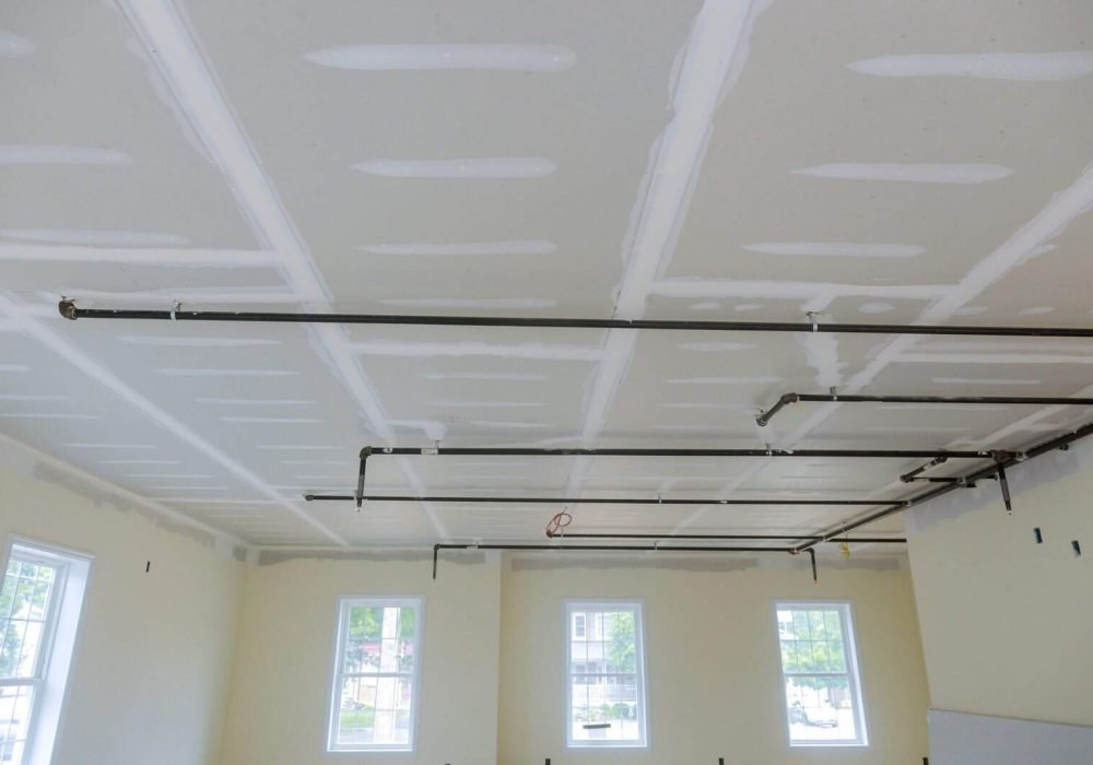 Interior ceiling with drywall and electrical wiring in progress.
