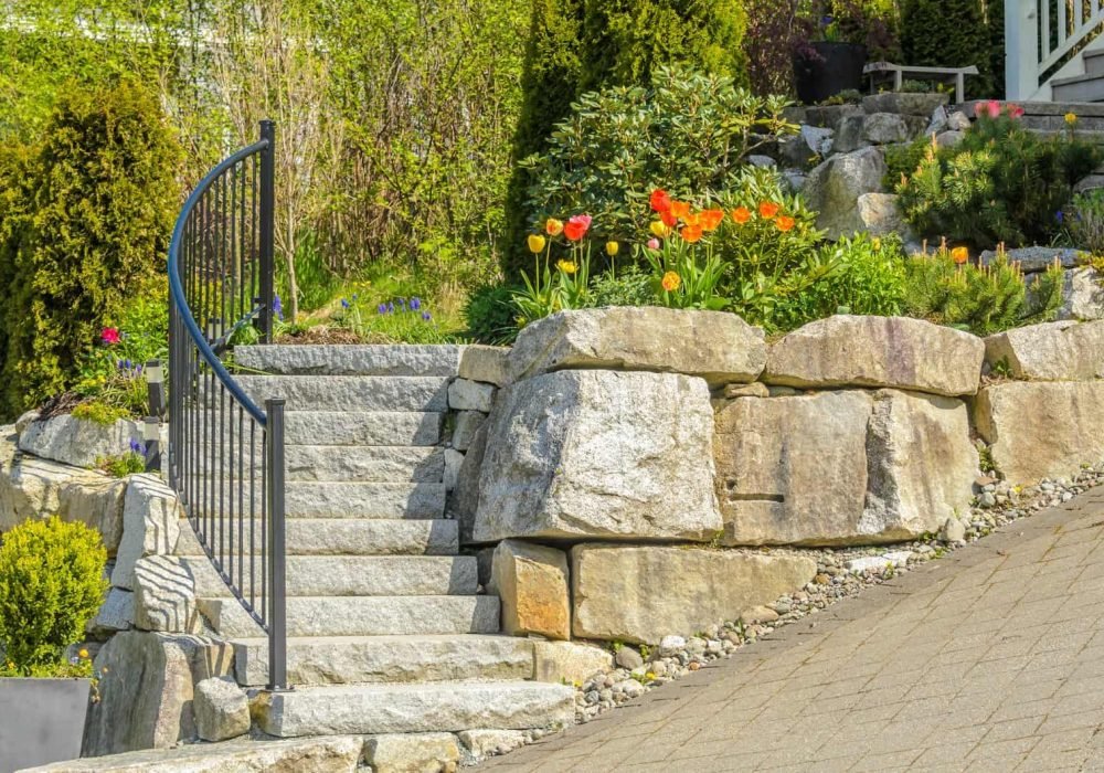 Retaining wall and garden stairs installation by R. Higuera's for durable landscape support.