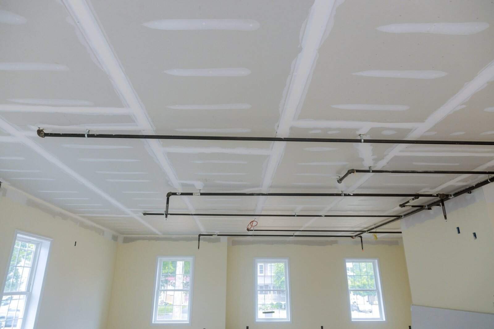 Interior ceiling with drywall and electrical wiring in progress.