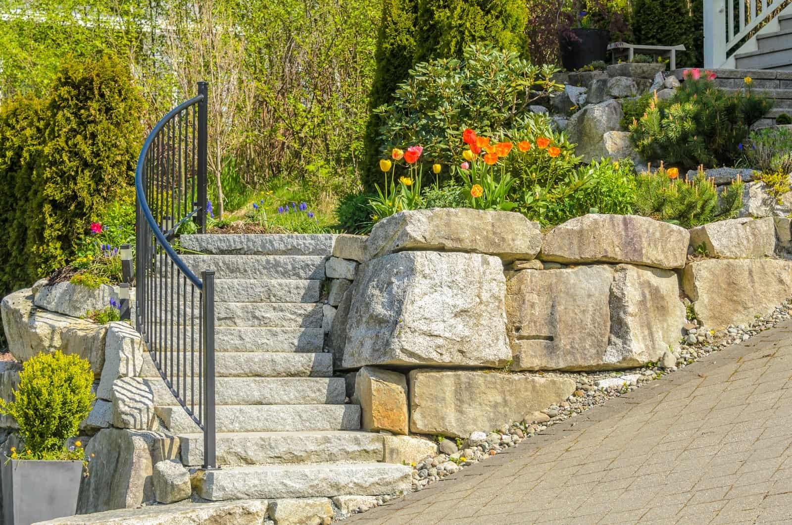 Retaining wall and garden stairs installation by R. Higuera's for durable landscape support.